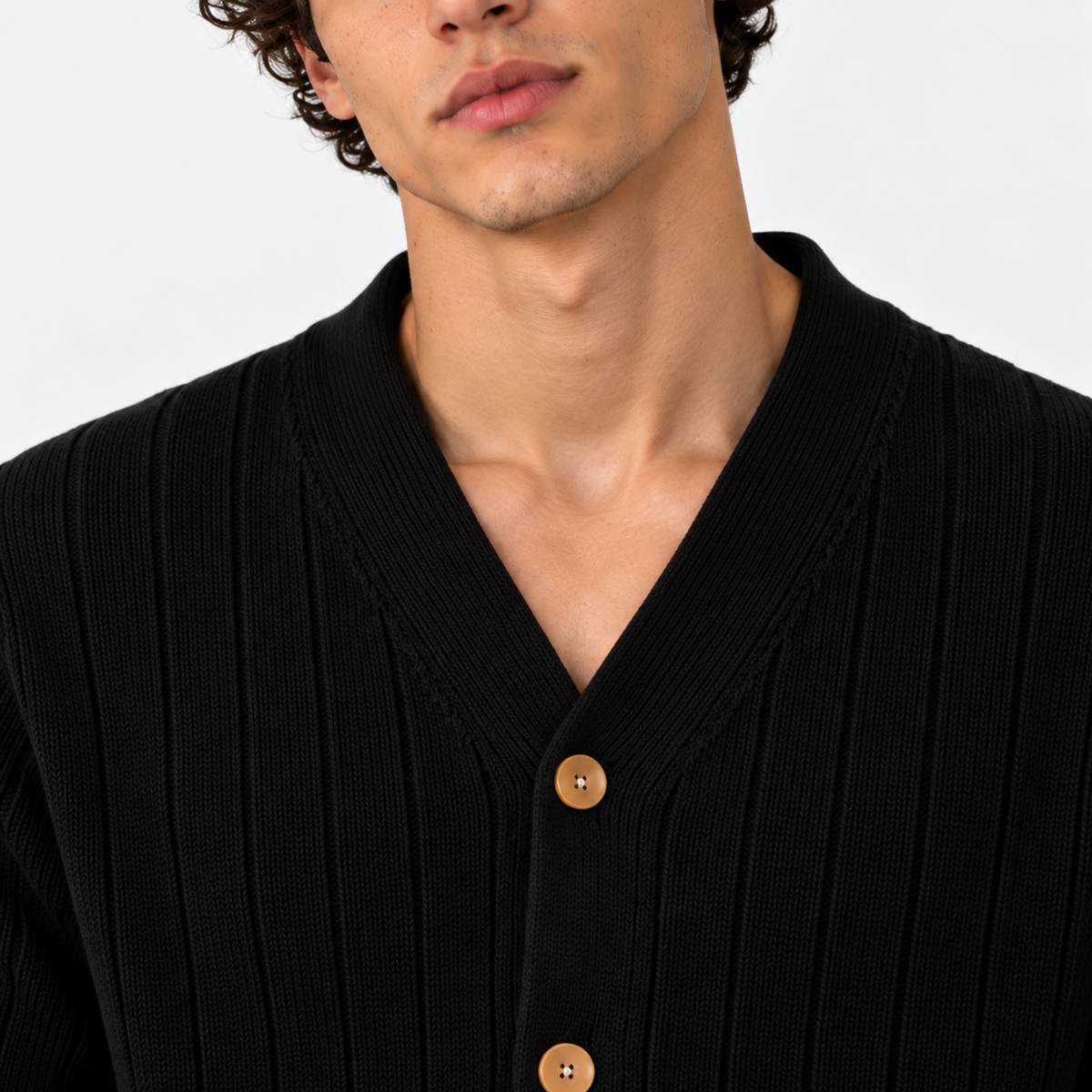 Close-up of men's black ribbed cardigan with V-neckline and wooden buttons