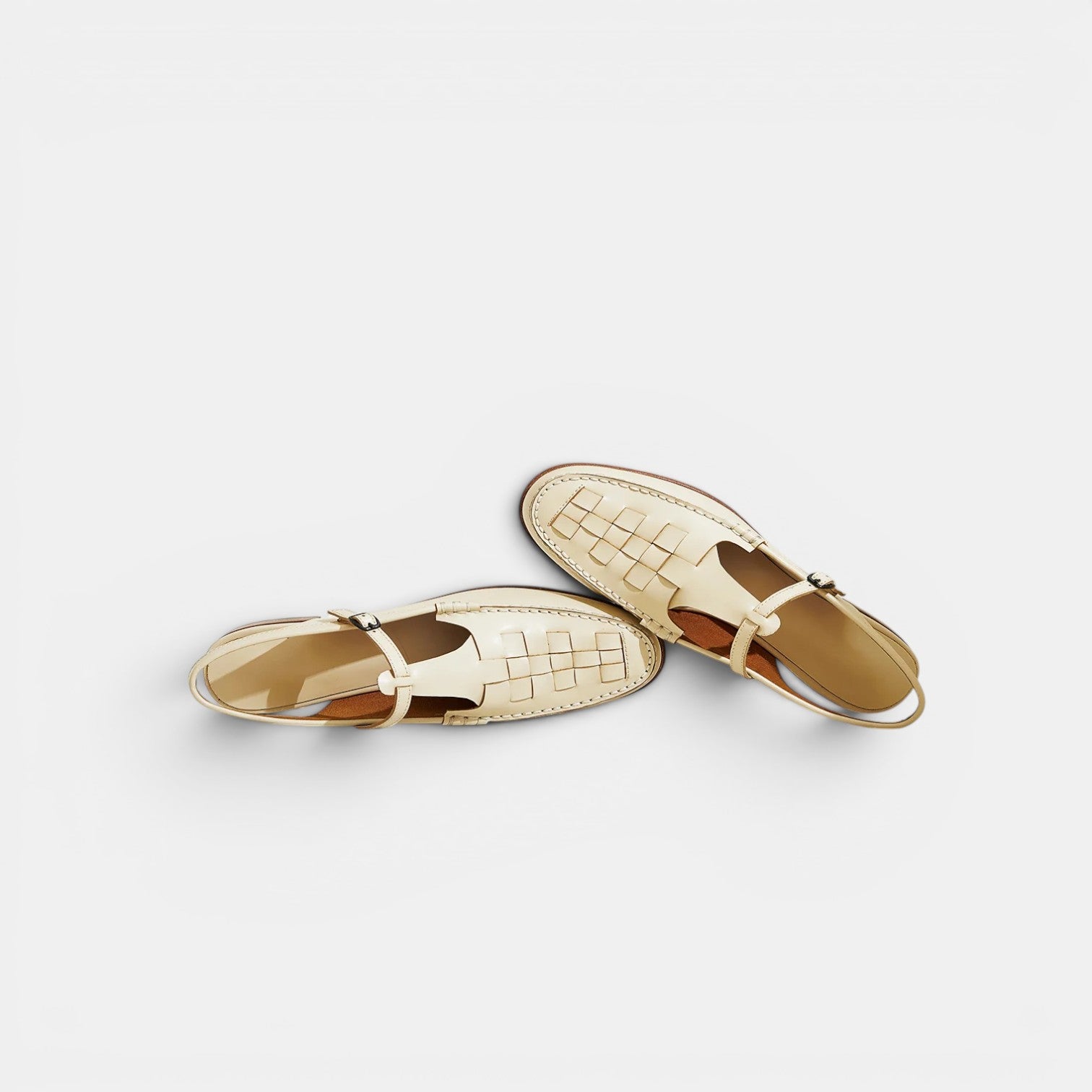 Pair of gold open-toe shoes on a light gray background