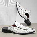 White leather shoes with brown soles on a light gray background