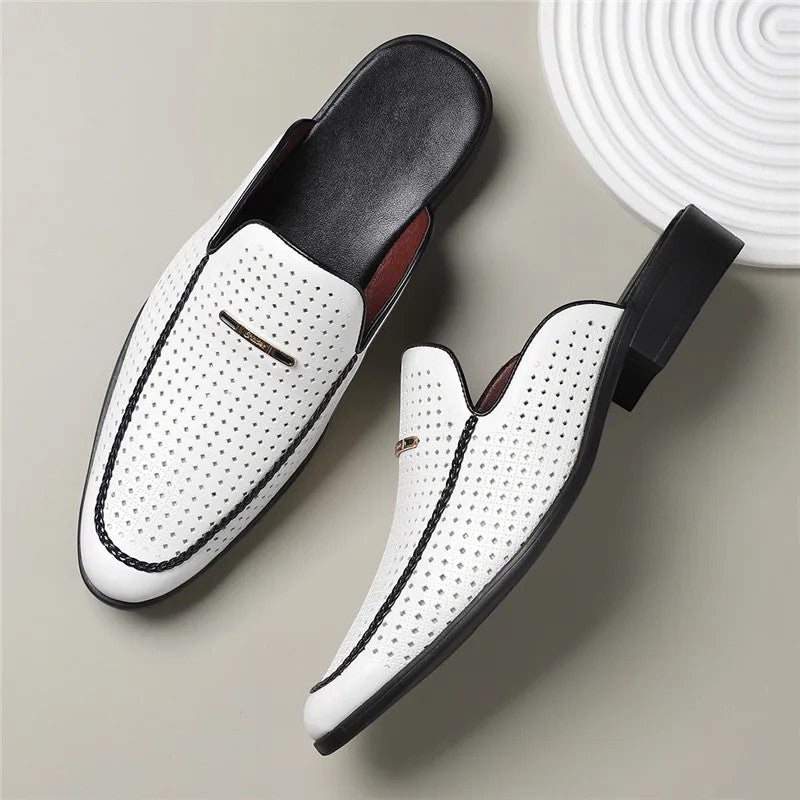 White loafers with black accents on a light gray background