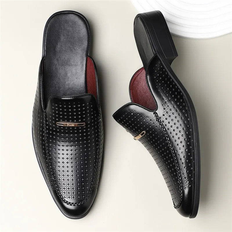 Black leather loafers with a textured pattern on a light background