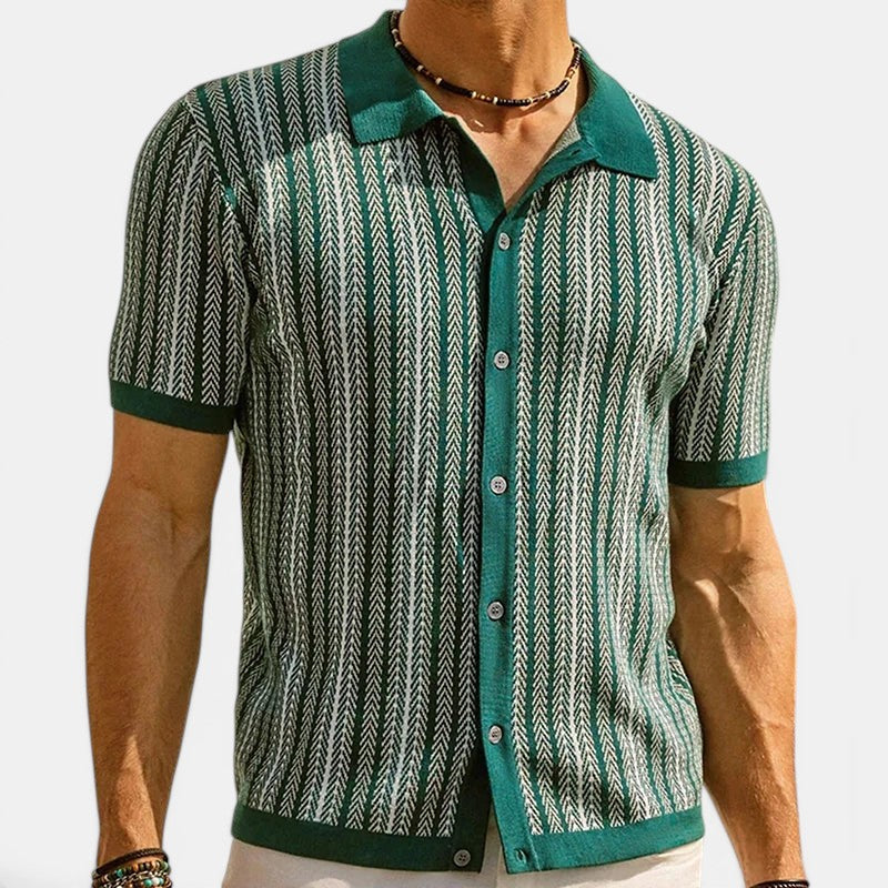 Man wearing a patterned shirt with green accents on a white background