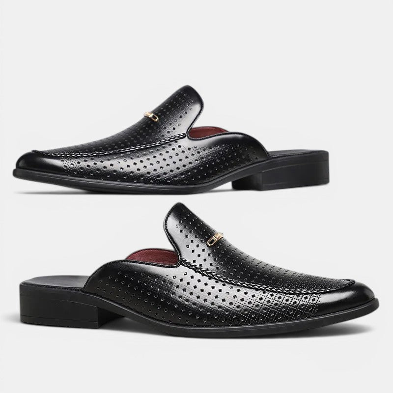 Black perforated loafers with brown insole on a white background