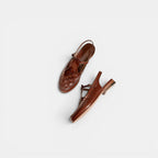 Pair of brown sandals on a white background
