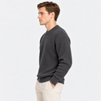Side view of a man wearing a charcoal gray ribbed knit crew neck sweater