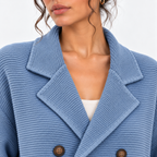 Close-up of women's light blue knit blazer with notched lapels and double-breasted buttons