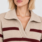 Close-up of women's striped knit sweater with textured collar and burgundy stripes