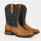 Women's tan leather cowboy boots with black embroidered shafts, western stitching, and low block heels