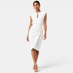 Woman wearing a white dress on a plain background