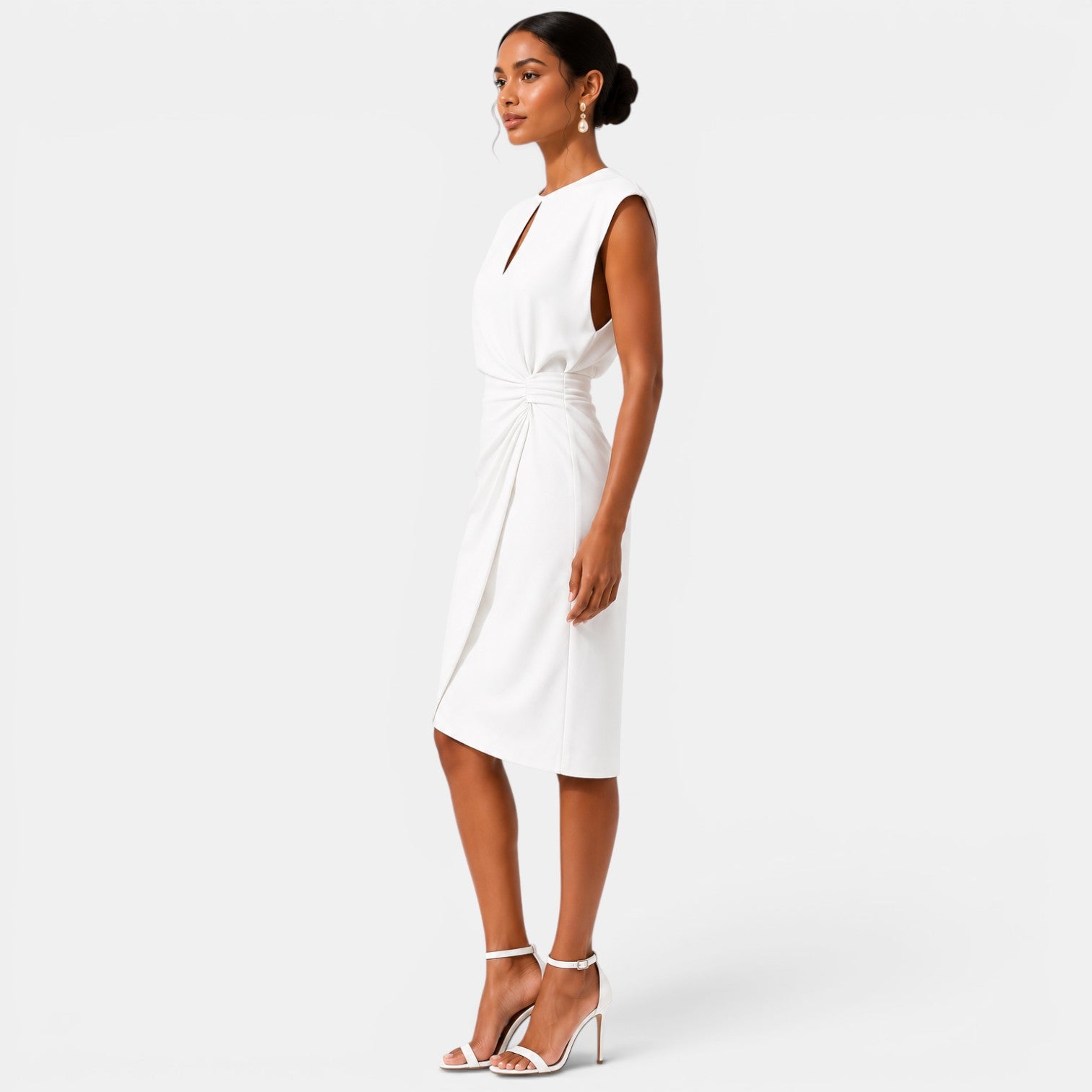 Woman wearing a white dress on a plain background