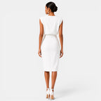 Woman wearing a white dress on a plain background