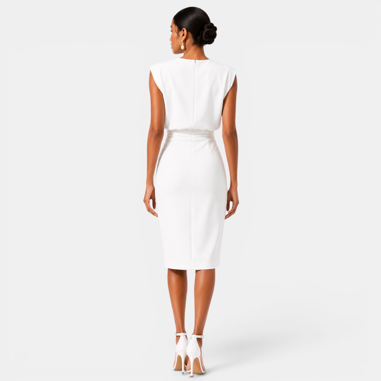 Woman wearing a white dress on a plain background