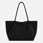 A black suede tote bag with dual shoulder straps, photographed against a clean white background.