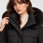 Close-up of women's black puffer coat with faux fur hood trim and high collar