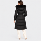 Back view of a women's black long puffer coat with hood and quilted design