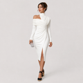 A woman models a white long-sleeve off-the-shoulder midi dress with a ruched, gathered design and a front slit, paired with black strappy heels and a small silver clutch, against a light gray studio background.