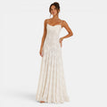 Woman wearing a white evening gown on a plain background