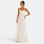 Woman wearing a white evening gown on a plain background