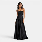 Woman wearing a black satin gown on a white background