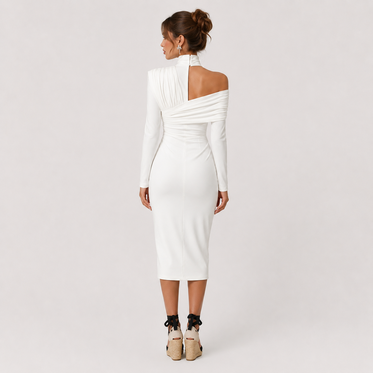 A woman wearing a white long-sleeve midi dress with an asymmetrical draped shoulder and high neck, shown from the back against a light gray studio background.
