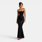 Woman wearing a black strapless gown on a white background