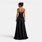Black evening gown with intricate back design on a white background