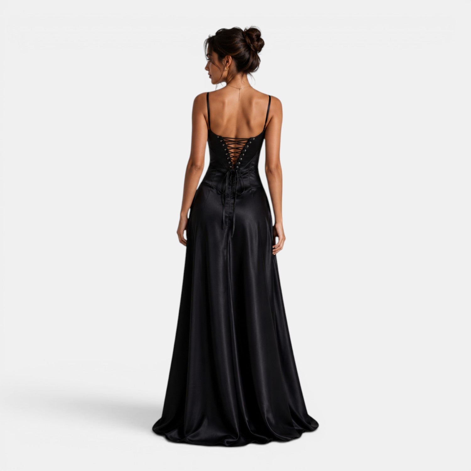 Black evening gown with intricate back design on a white background