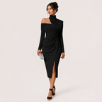 A woman models a black long-sleeve off-the-shoulder midi dress with a ruched twist detail at the waist and a front slit, paired with black platform heels and a small silver clutch, against a light gray studio background.