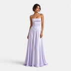 Woman wearing a long lavender dress on a white background
