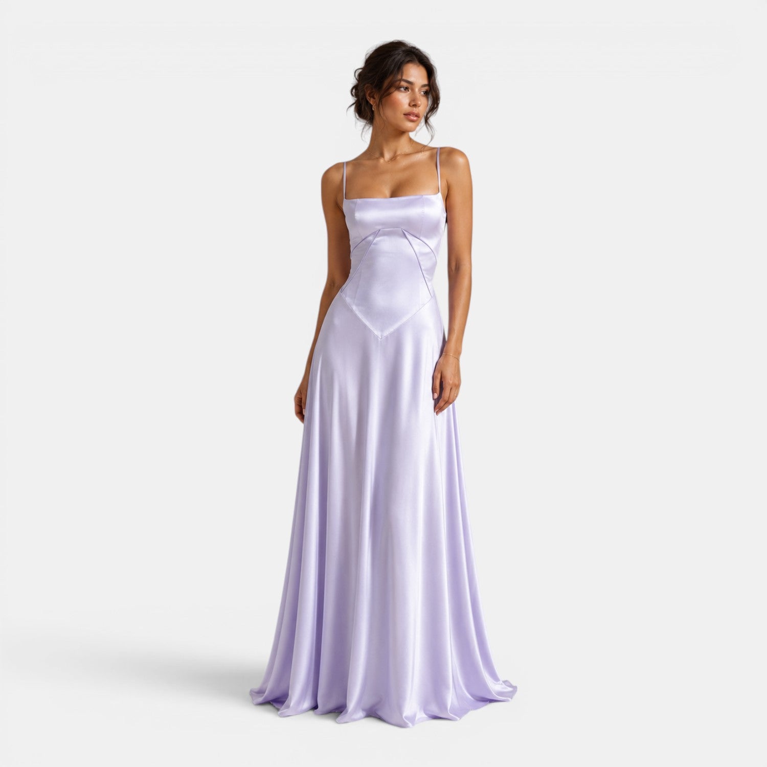Woman wearing a long lavender dress on a white background