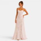 Woman wearing a long, light-colored dress on a white background