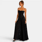 Woman wearing a black lace evening gown on a white background