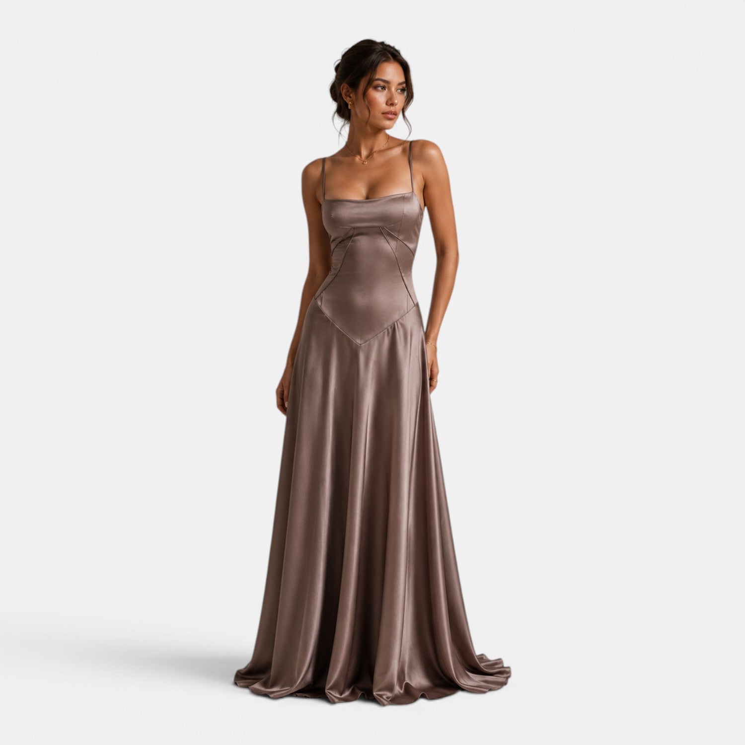 Woman wearing a long, elegant brown dress on a white background
