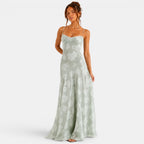 Woman wearing a light green floral dress on a white background
