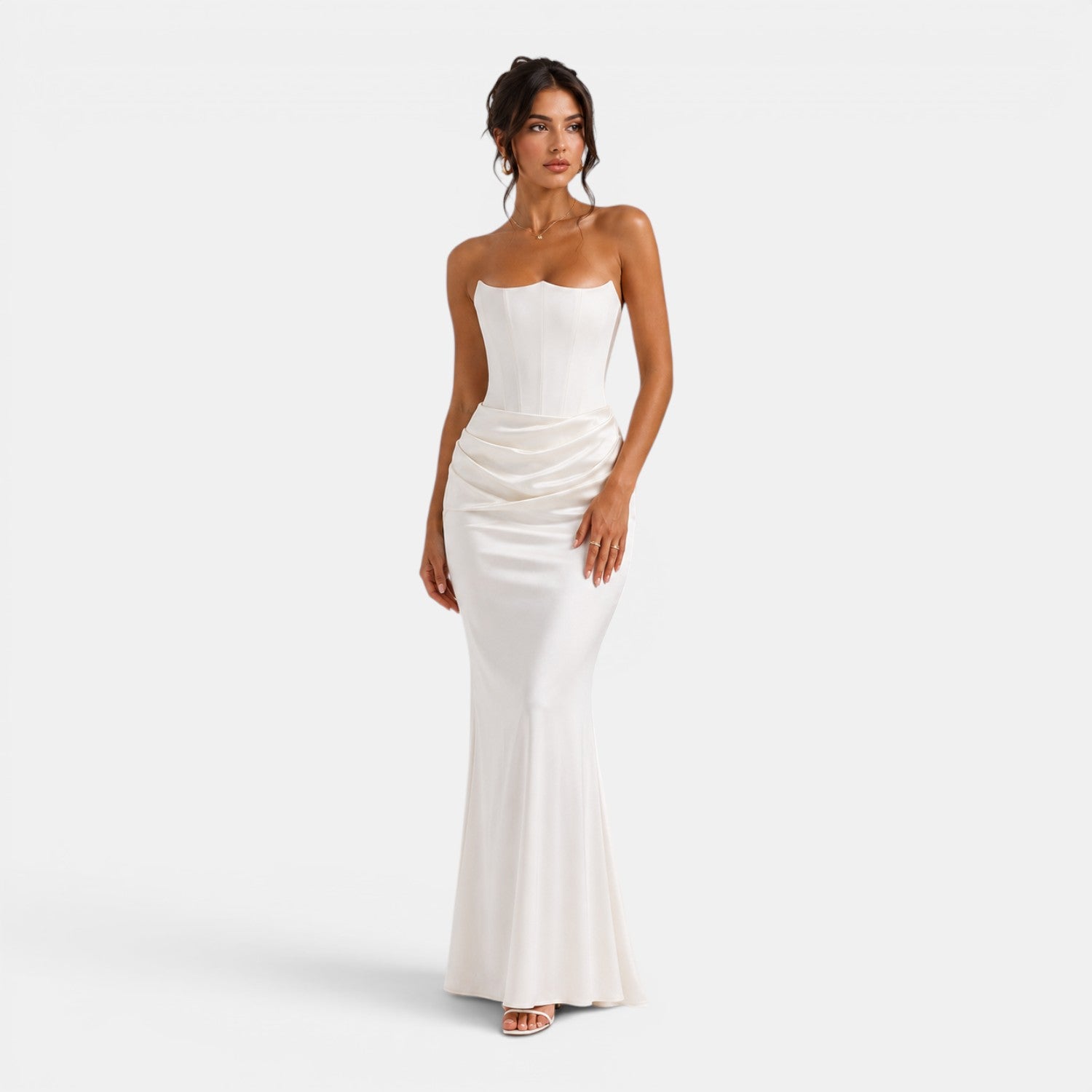 Woman wearing a white strapless gown on a white background