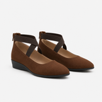 A pair of women's brown suede Mary Jane-style wedge shoes with dark brown ankle straps and black wedge heels, shown on a light gray background.