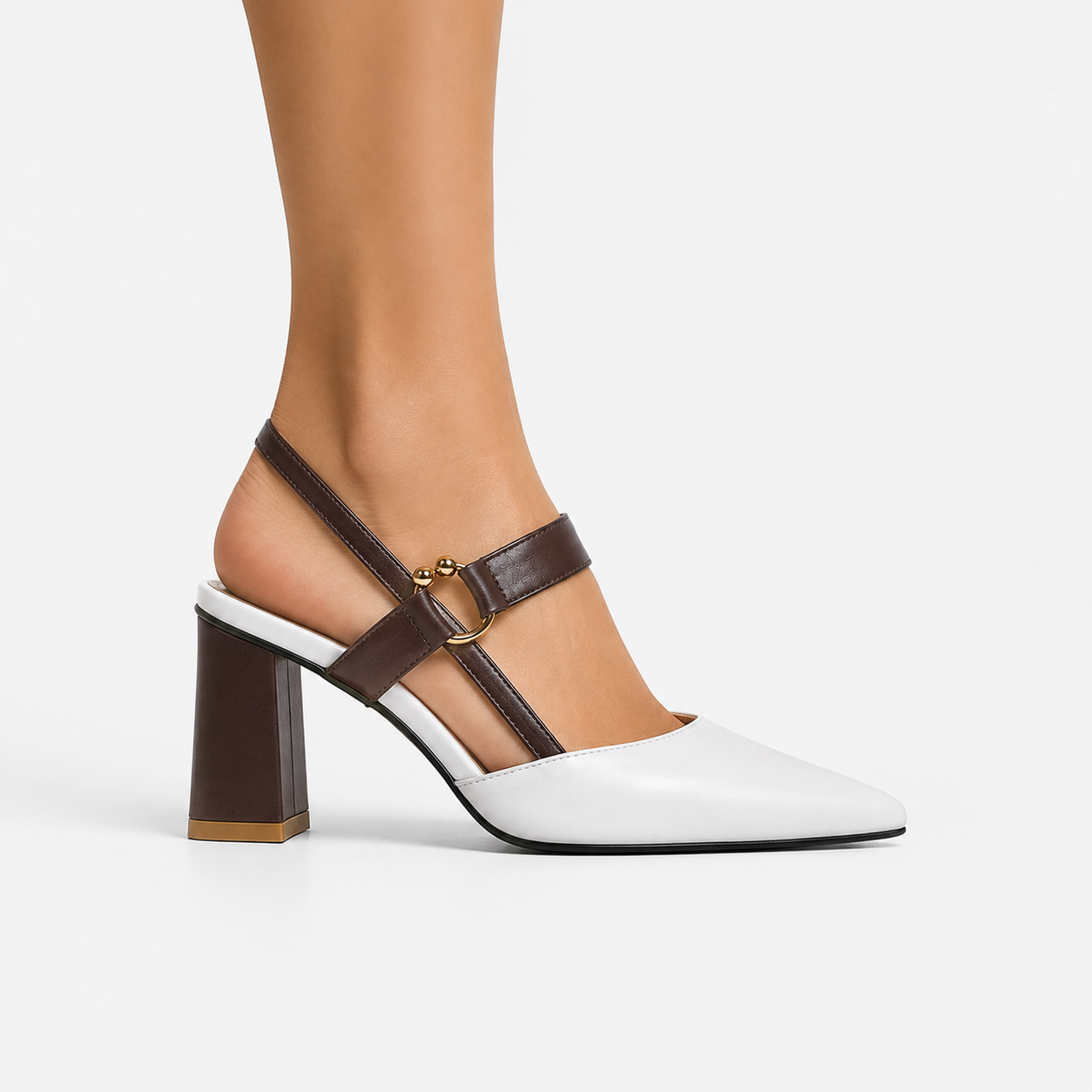 A woman's high-heeled slingback shoe with a white toe and back strap, dark brown straps and block heel, and a small gold buckle, shown on a model's foot against a light gray background.