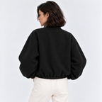 Back view of a women's black bomber jacket with ribbed hem and cuffs