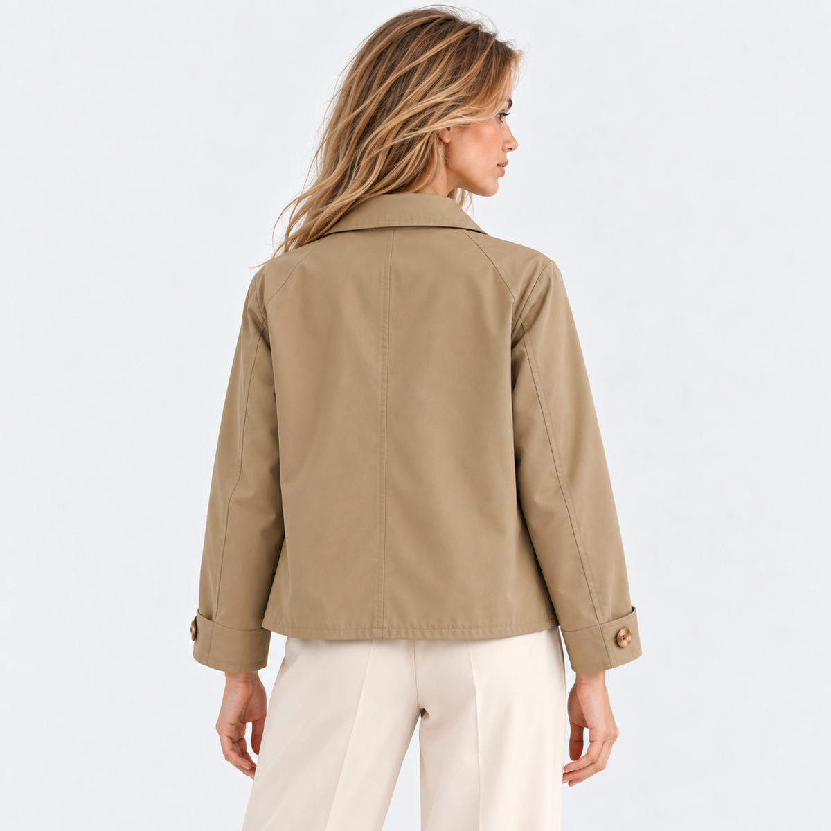 Back view of a woman wearing a beige button-front jacket