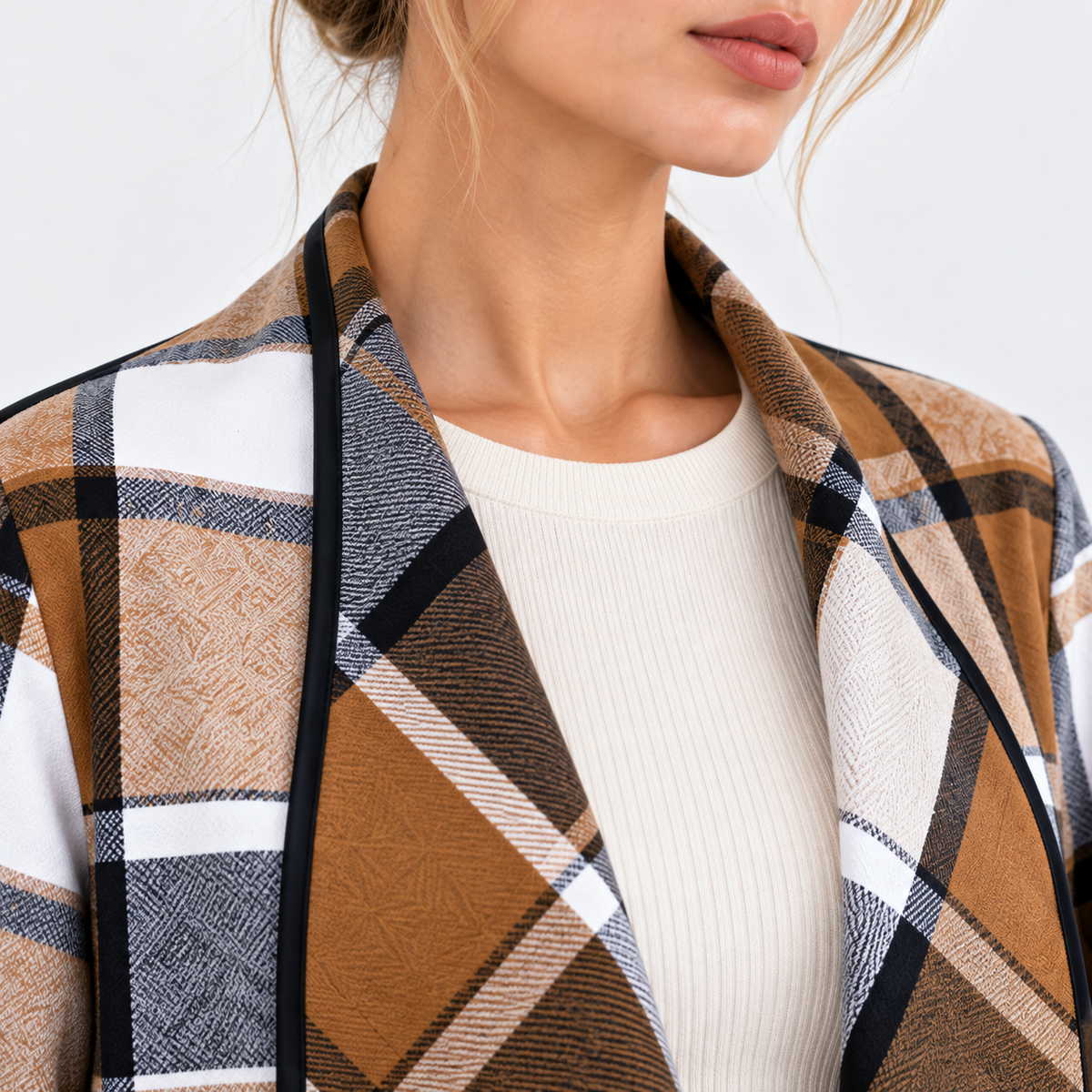 Close-up of brown and black plaid blazer collar and check pattern