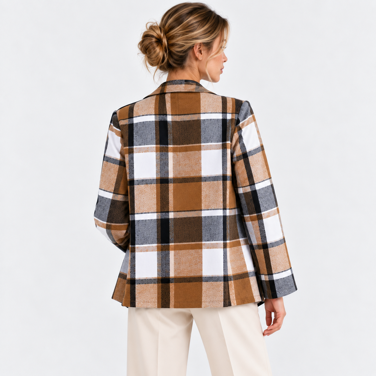 Back view of a woman wearing a brown and black plaid blazer jacket