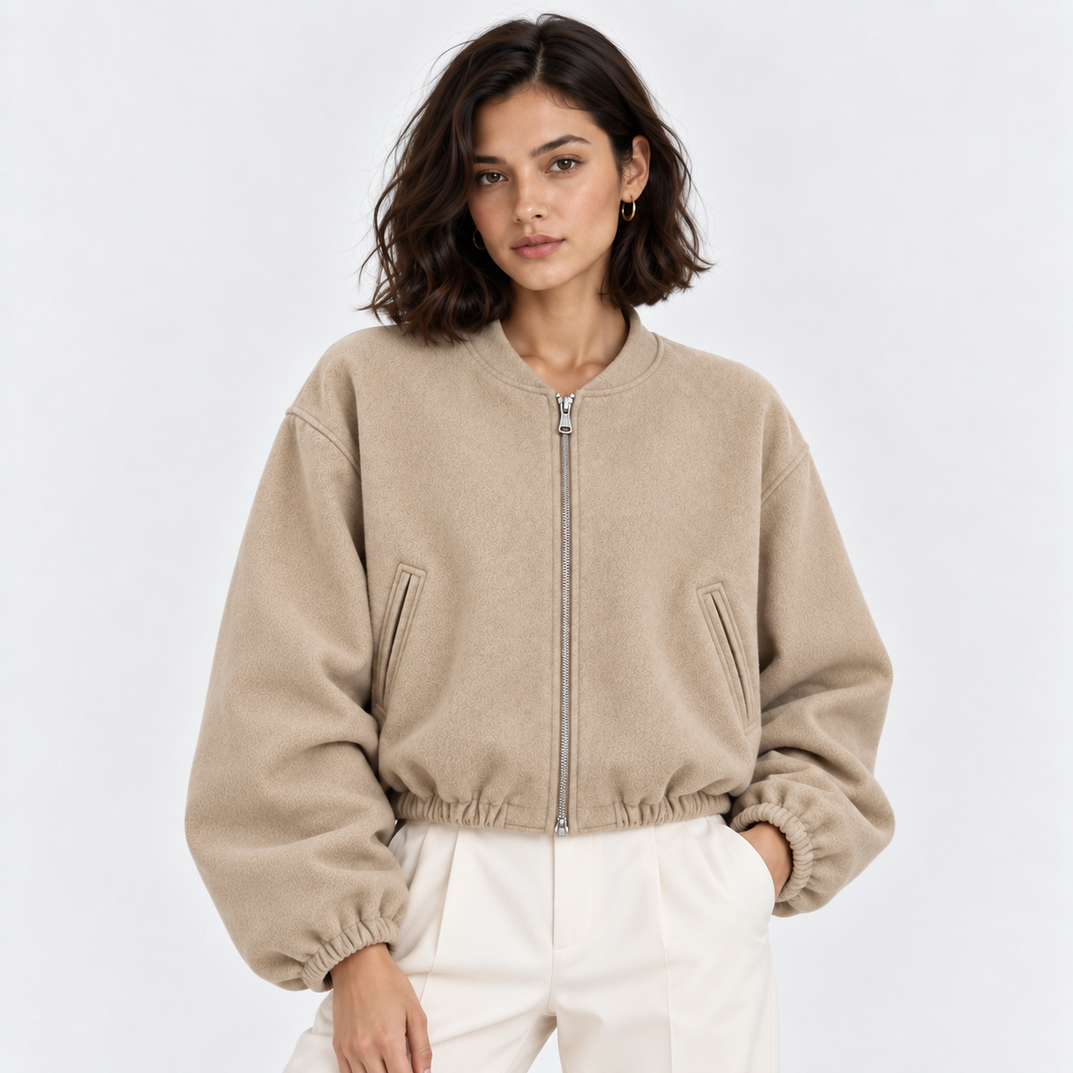 Women's beige zip-up bomber jacket with ribbed cuffs, collar, and hem