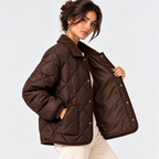 A woman models a dark brown diamond-quilted jacket with a matching brown collar, shown from the waist up against a light gray studio background.