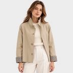 Women's beige button-front jacket with checked cuffs and white pants
