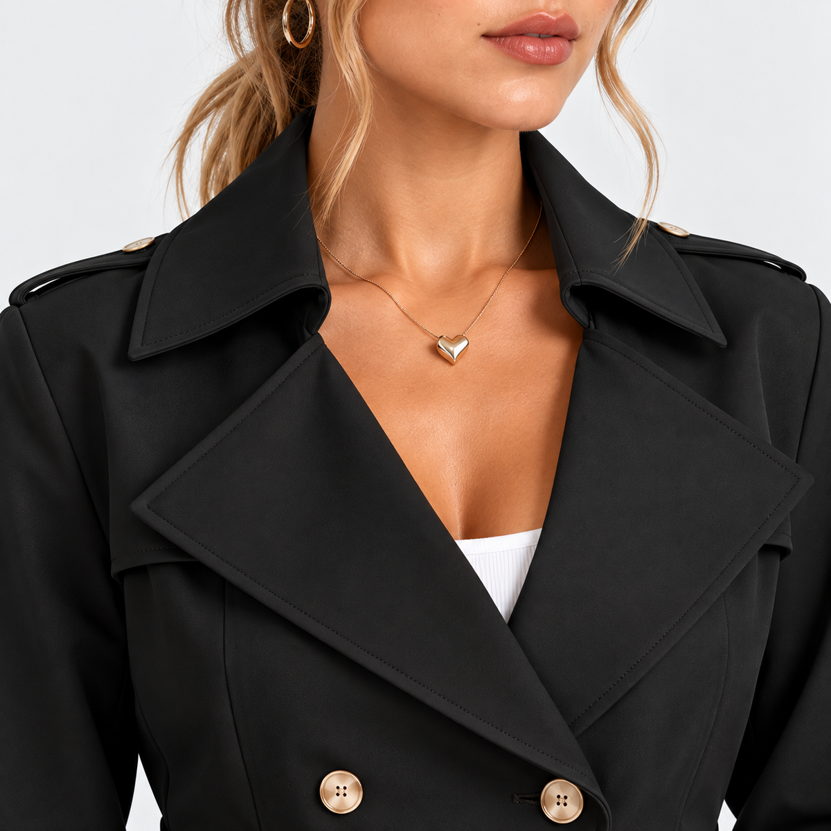 Close-up of black double-breasted blazer collar and gold button details