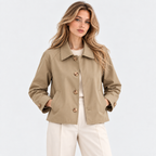 Women's beige button-front jacket with collared neckline and white pants