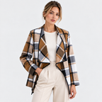 Women's plaid blazer jacket with brown and black check pattern over a white top and pants