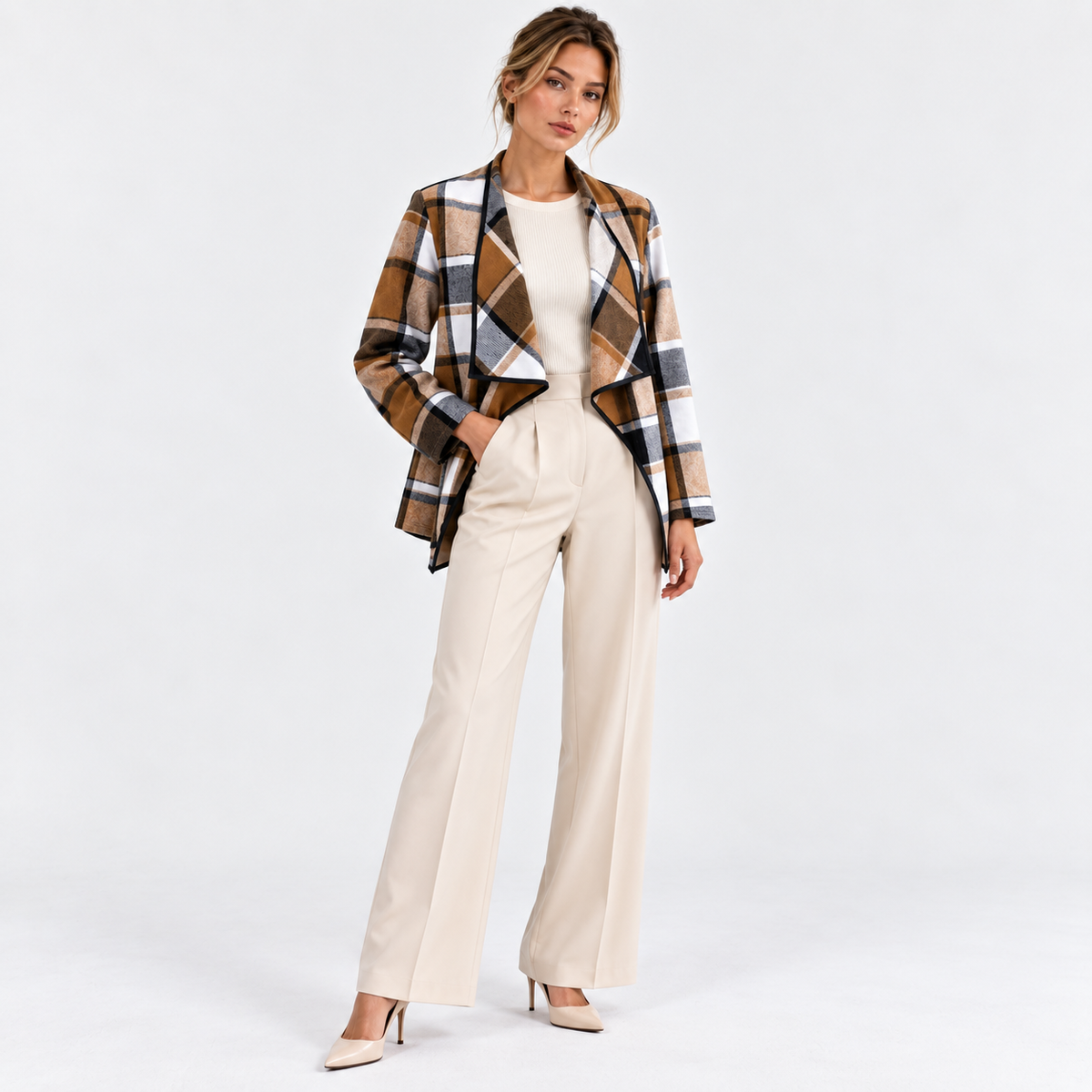 Woman wearing a brown and black plaid blazer with white tailored pants