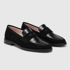A pair of black loafers with a mix of matte suede and glossy crocodile-embossed leather panels, shown on a light gray background.