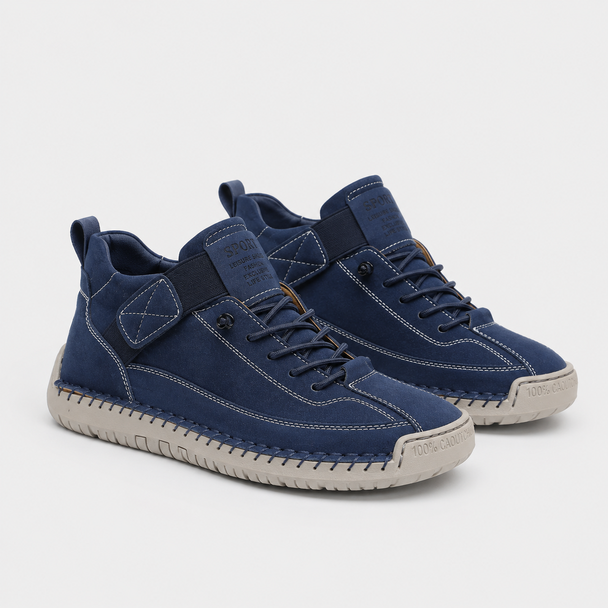 A pair of mid-top sneakers in navy blue suede and canvas with light beige soles, shown on a light gray background.